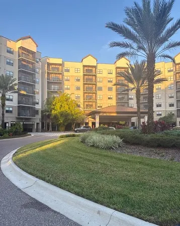 a view of a big building with a big yard and plants