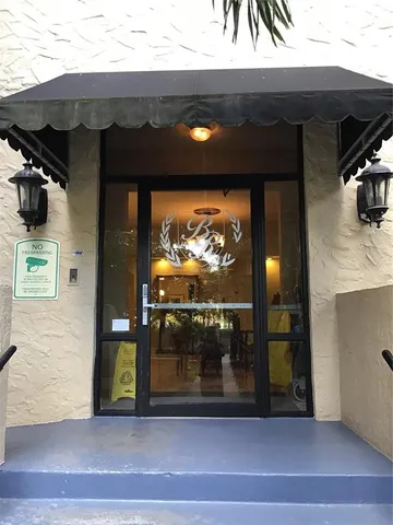 a living room with furniture a window and a chandelier