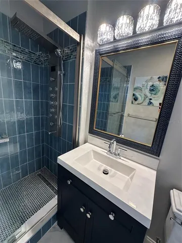 a bathroom with a sink a toilet and a mirror