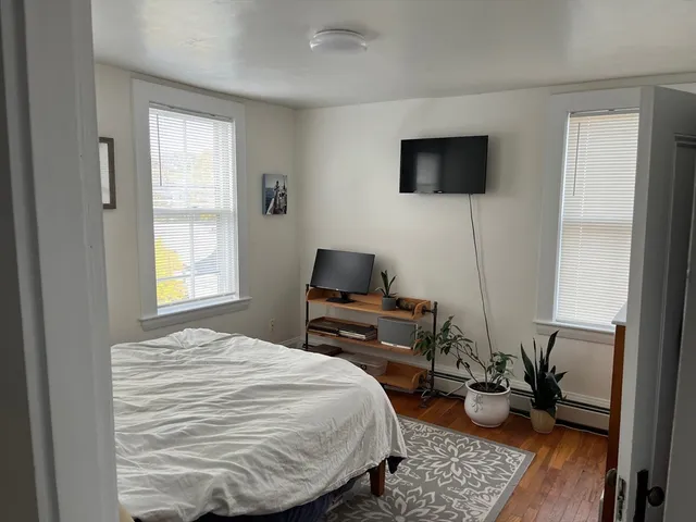 a bedroom with a bed and flat screen tv