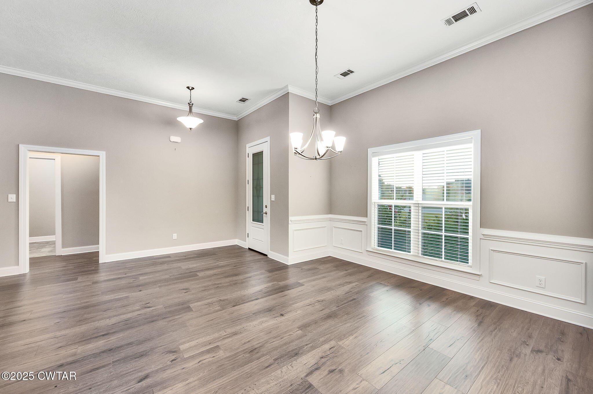 92 Samuel Drive Jackson, TN 38305 - Photo 2 of 23 an empty room with wooden floor and windows