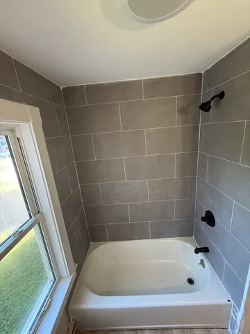 a bathroom with a tub and a shower