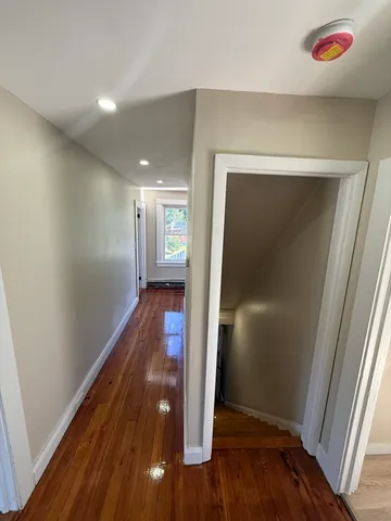 a view of hallway with wooden floor