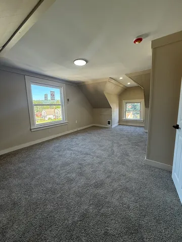 an empty room with windows and entrance