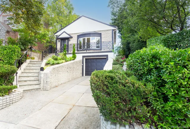 a front view of a house with a garden