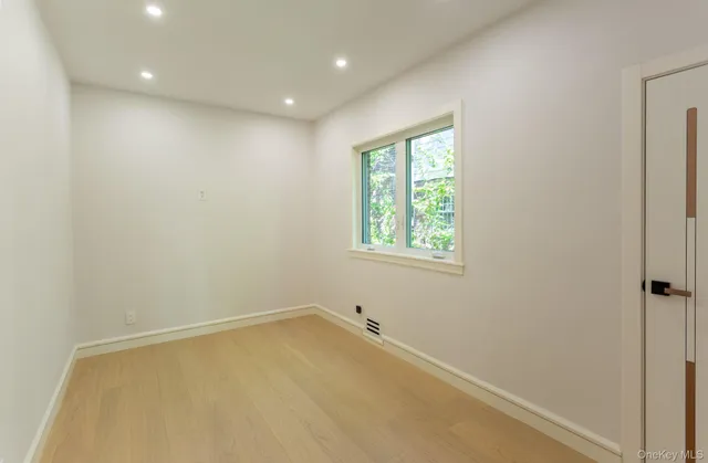 an empty room with windows and closet