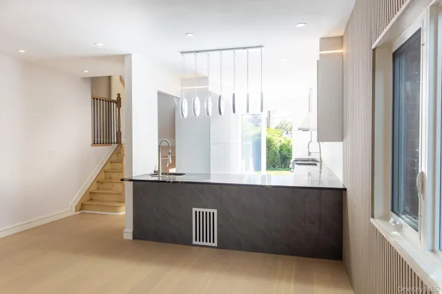 a kitchen with stainless steel appliances granite countertop a refrigerator a sink and a dishwasher