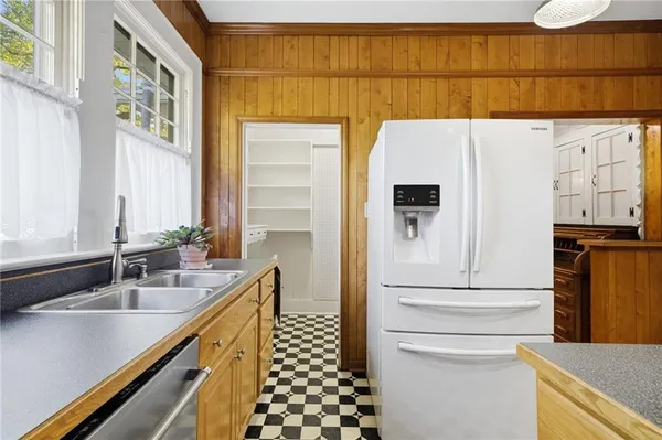 a kitchen with a sink and a refrigerator