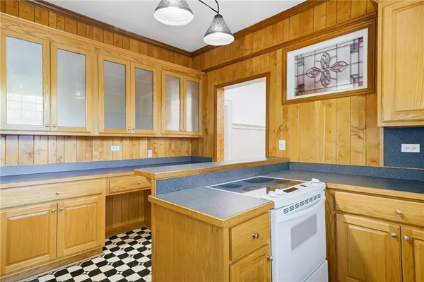 a utility room with stainless steel appliances granite countertop a stove and a sink