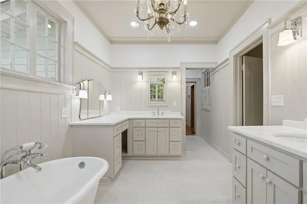 a bathroom with a bathtub sink and mirror