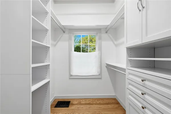 a view of walk in closet with empty racks