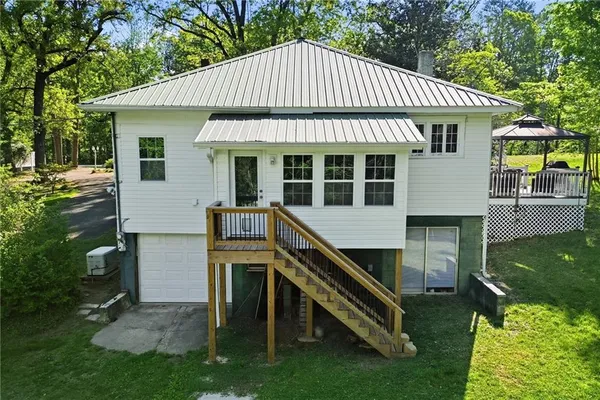 a front view of a house with a yard table and chairs