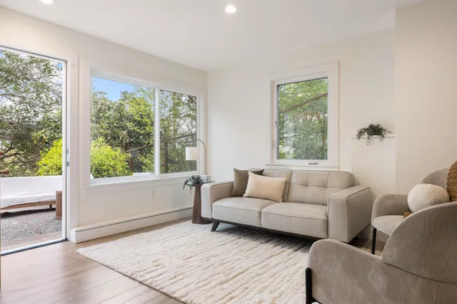 a living room with furniture and a painting on the wall