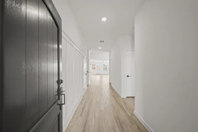 a view of a hallway with wooden floor
