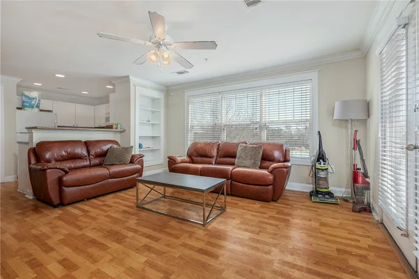 a living room with furniture and a chandelier