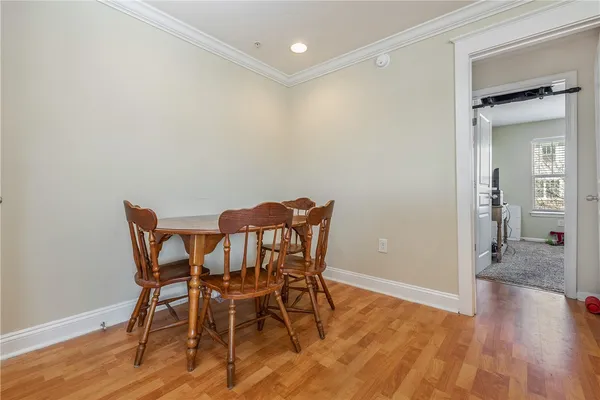 a view of a dining room with furniture and wooden floor