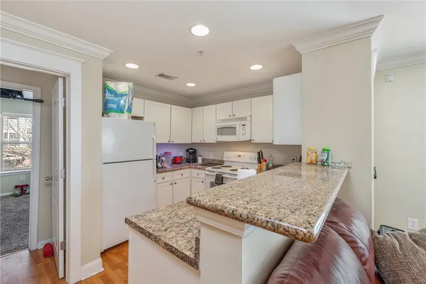 a kitchen with refrigerator and stove