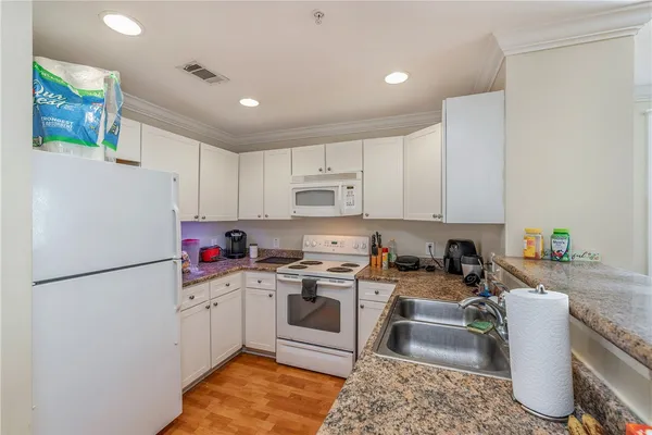a kitchen with a sink cabinets and stainless steel appliances
