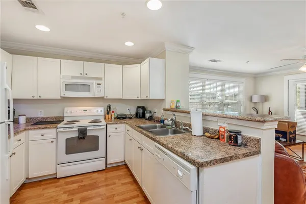a kitchen with stainless steel appliances granite countertop a sink stove and cabinets