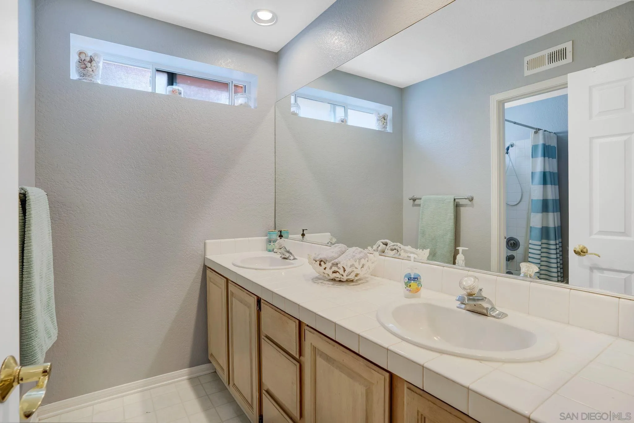 1372 Graham Place Escondido, CA 92026 - Photo 19 of 63 a bathroom with a sink and a mirror