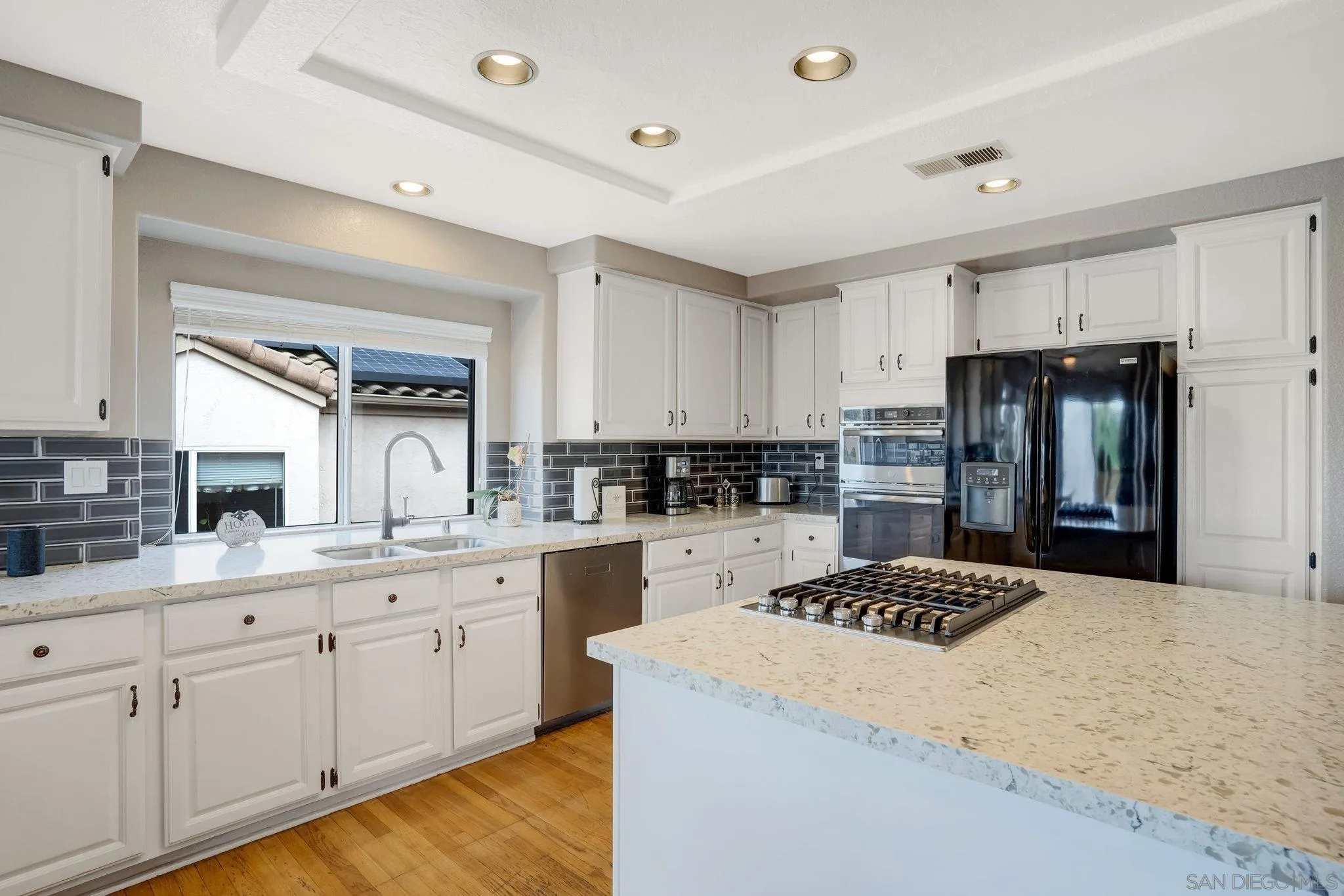 1372 Graham Place Escondido, CA 92026 - Photo 28 of 63 a kitchen with granite countertop a sink a counter top space stainless steel appliances and cabinets