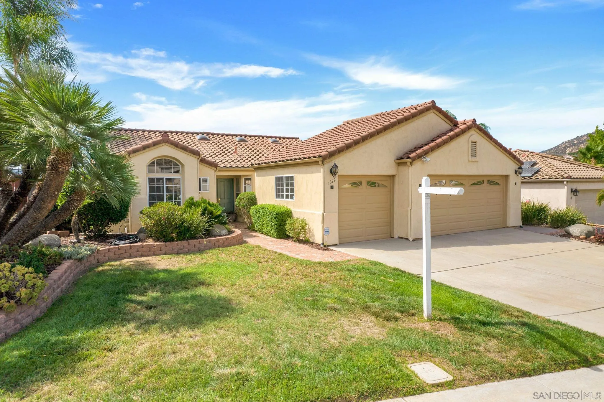 1372 Graham Place Escondido, CA 92026 - Photo 56 of 63 a view of a yard in front of a house with plants and large tree