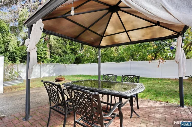 a backyard of a house with table and chairs