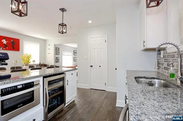 a kitchen with stainless steel appliances granite countertop a stove and a sink