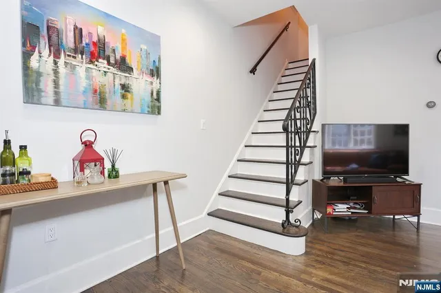 a view of entryway with wooden floor and stairs