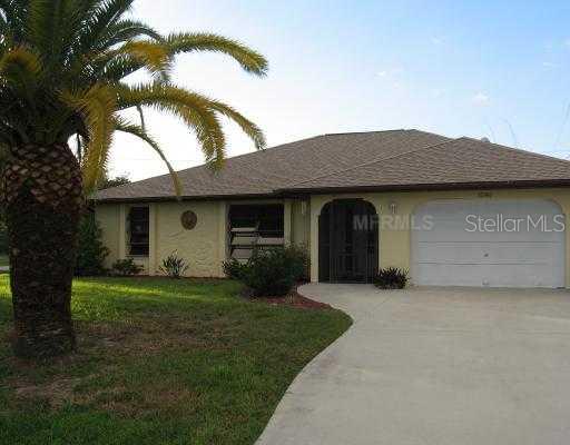 1240 Kimball Road Venice, FL 34293 - Photo 1 of 1 a front view of a house with a garden and yard