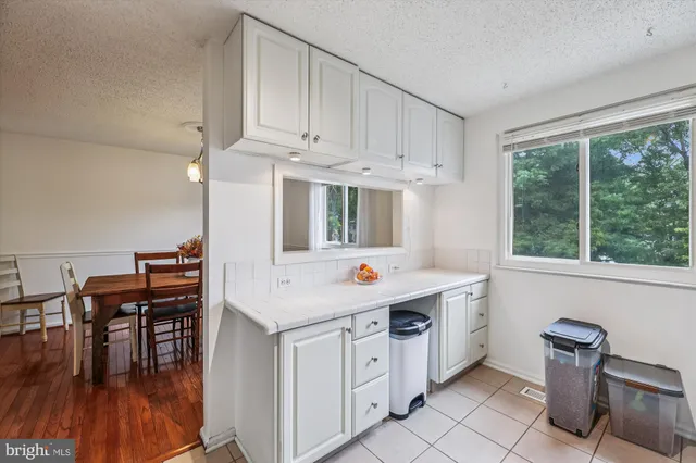 a kitchen that has a sink and chair