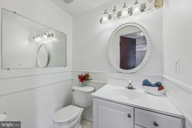 a bathroom with a sink mirror and toilet