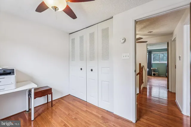 a view of a hallway and wooden floor and a livingroom view