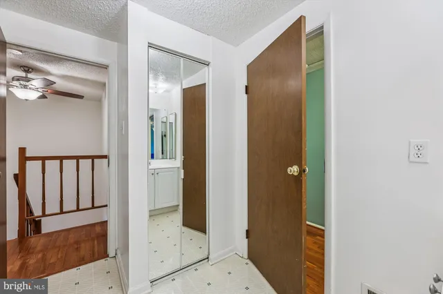 view of a bathroom with a glass door and mirror