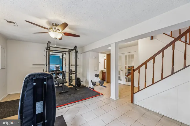 a view of a livingroom with stairs and furniture