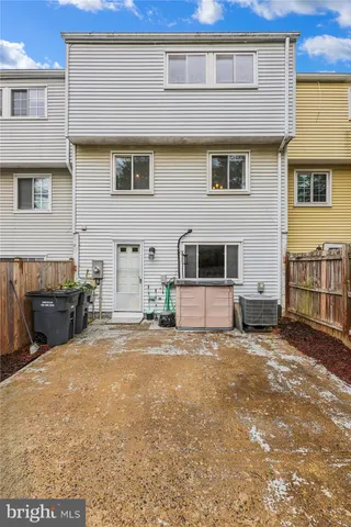 a view of a house with wooden fence