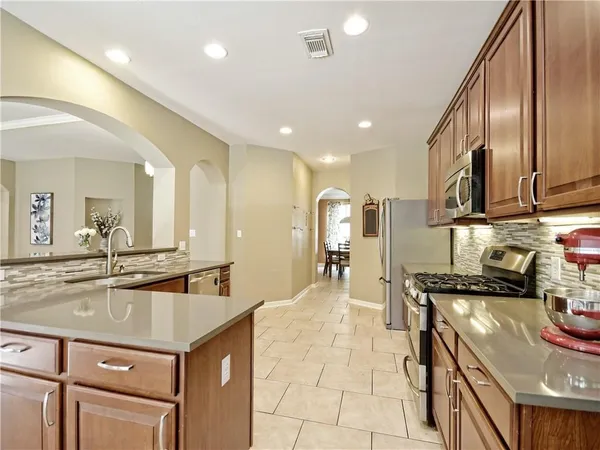 a kitchen with kitchen island granite countertop a sink and counter space