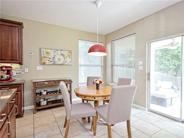 a view of a dining room with furniture large window and outside view
