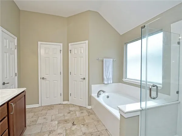 a bathroom with a bathtub and a sink
