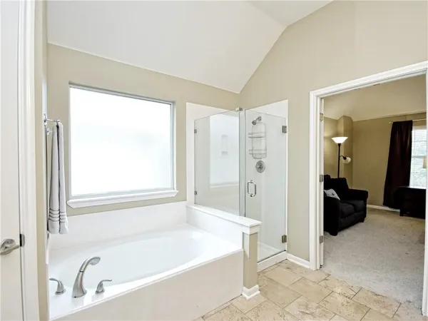 a bathroom with a bathtub and a shower