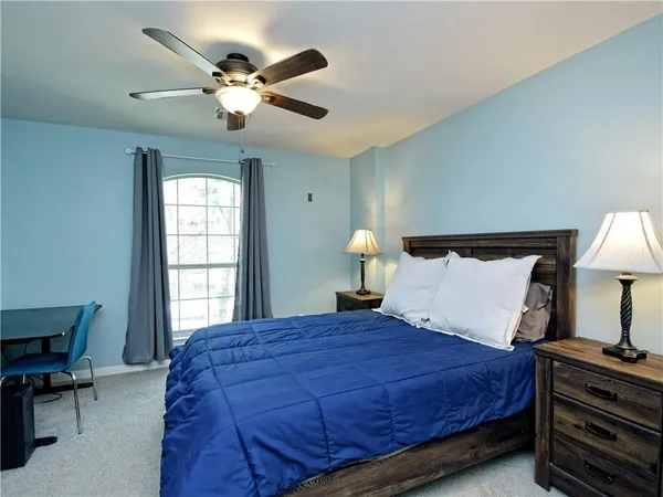 a bedroom with a bed and window