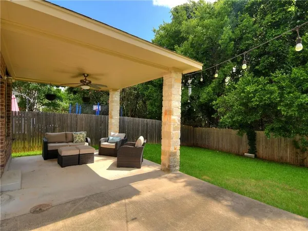 a view of a patio with chairs and plants