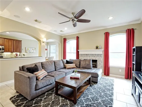 a living room with furniture a fireplace and a large window