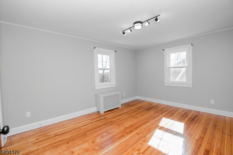 13 Clark Street Summit, NJ 07901 - Photo 13 of 24 a view of empty room with wooden floor and fan