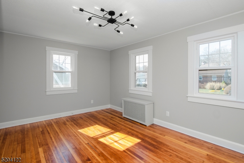13 Clark Street Summit, NJ 07901 - Photo 14 of 24 a view of empty room with wooden floor and fan