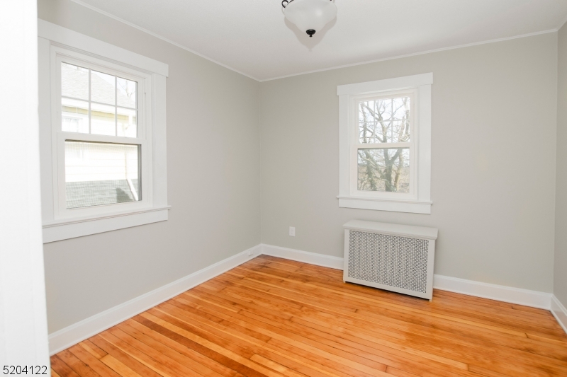 13 Clark Street Summit, NJ 07901 - Photo 15 of 24 an empty room with wooden floor and windows