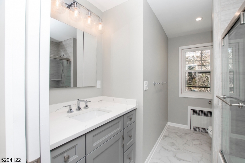 13 Clark Street Summit, NJ 07901 - Photo 16 of 24 a bathroom with a sink double vanity and a mirror