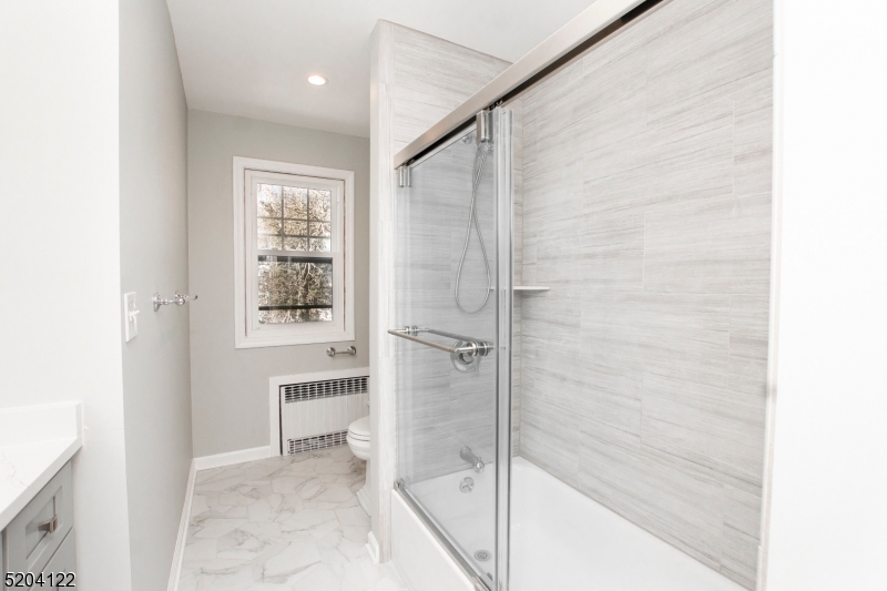 13 Clark Street Summit, NJ 07901 - Photo 17 of 24 a bathroom with a bathtub and a shower