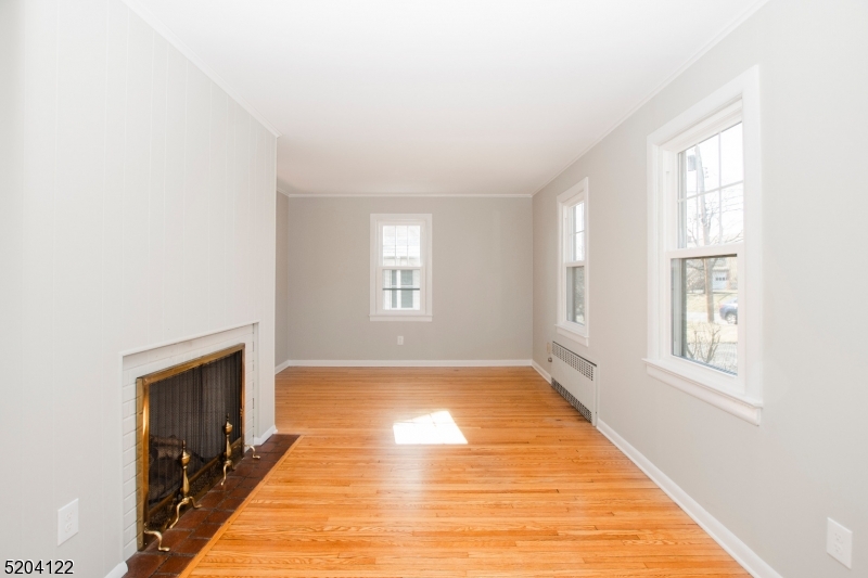 13 Clark Street Summit, NJ 07901 - Photo 4 of 24 a view of an empty room with a window and wooden floor