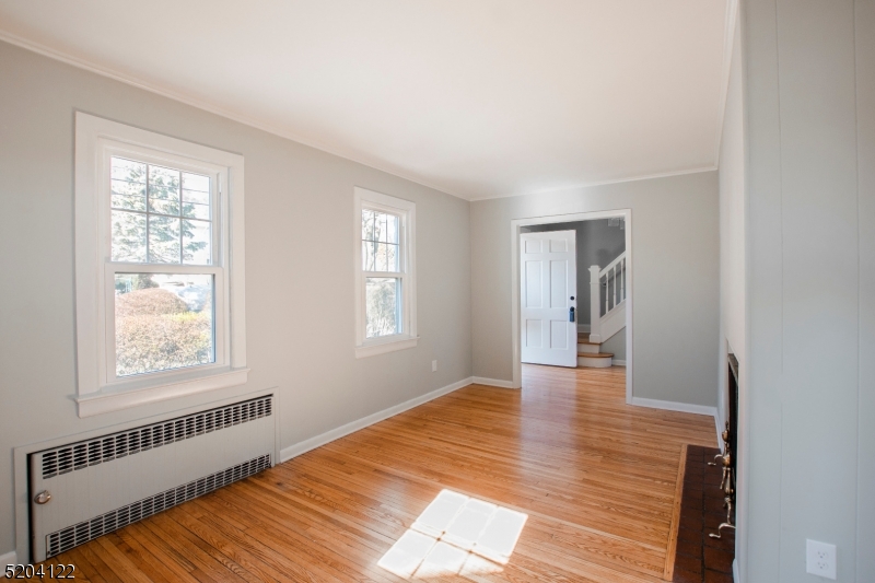 13 Clark Street Summit, NJ 07901 - Photo 5 of 24 a view of an empty room with wooden floor and a window